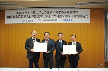 左から順に協定書を手にする石原修学長、浅野健司市長、井上良介理事長、松尾直規工学部長