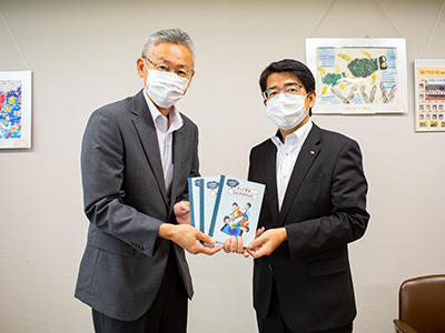 ガイドブックを持つ前田事務局長と加藤教育長