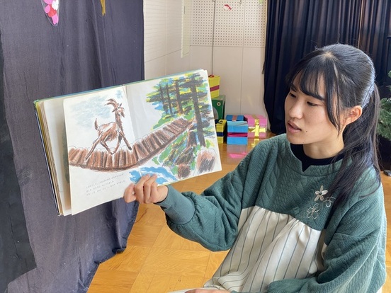 読み聞かせをする保育士職員