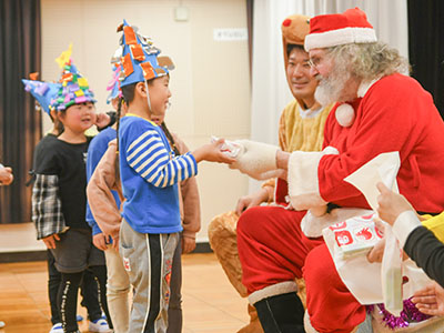 園児にプレゼントを渡す、サンタクロース